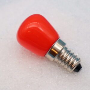 Glühbirne E14 (LED) „Orange“ Glühbirne auf Häufchen aus Salz liegend in Nahaufnahme