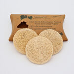 a group of round loofah pads to a cardboard box