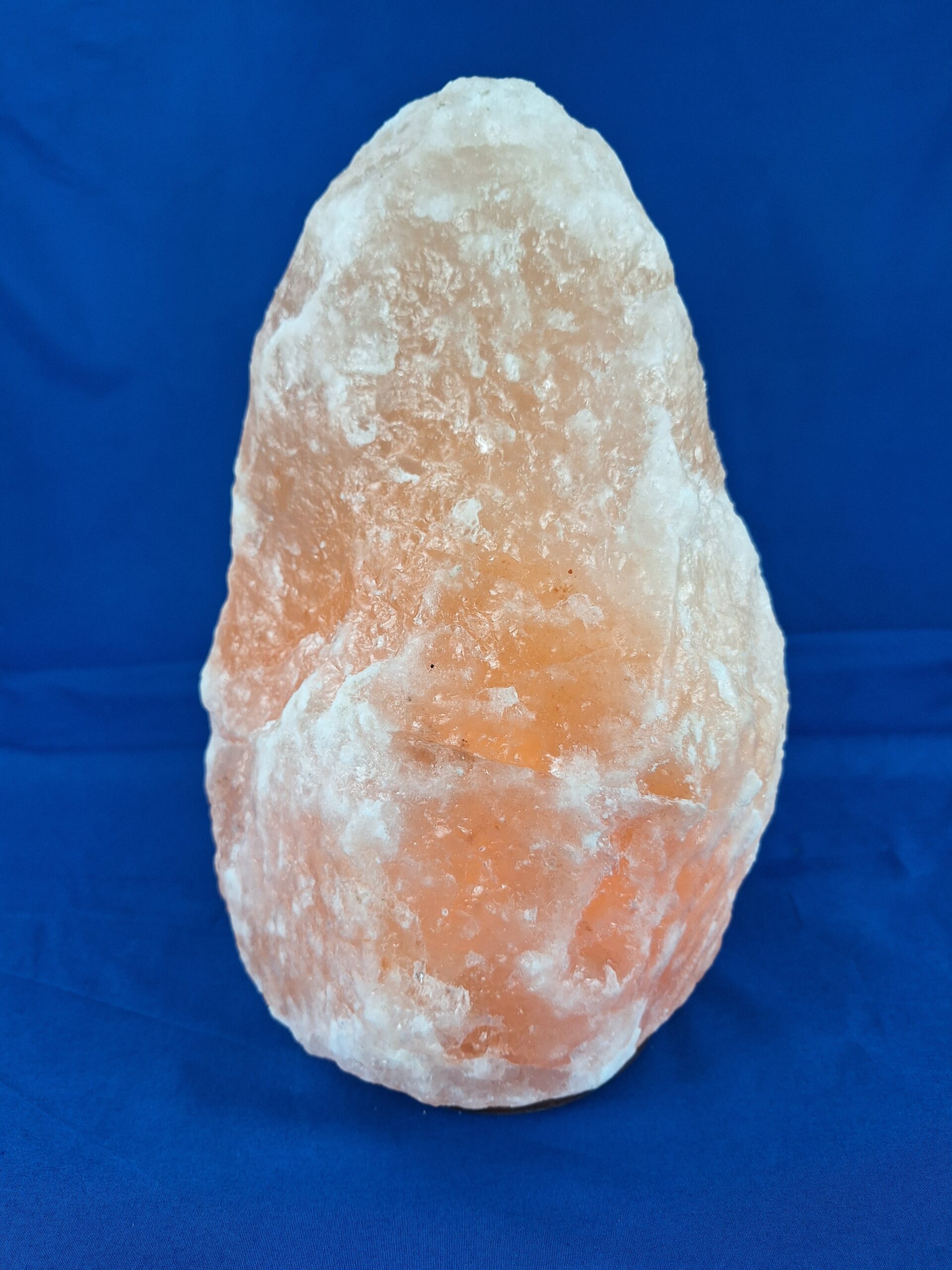 Salzlampe a rock on a blue surface