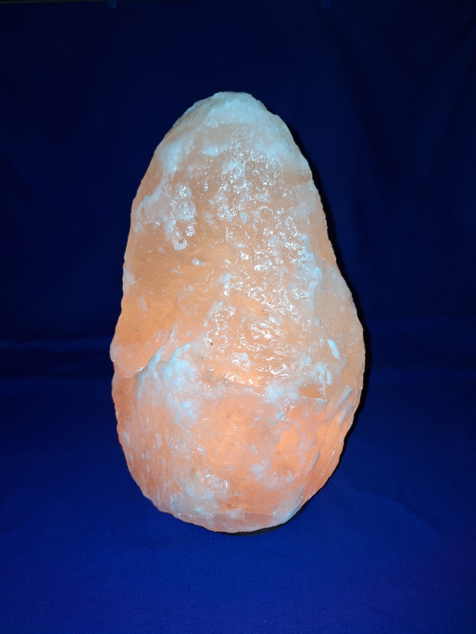 Salzlampe a salt lamp on a blue surface